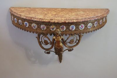 a small table with a marble top on a wall