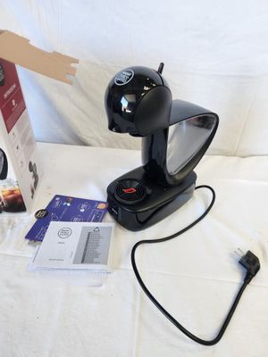an image of a coffee maker with a box of coffee in front of it