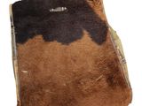 a brown and black cow skin purse on a white background