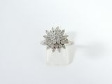 a close up of a diamond ring on a white surface