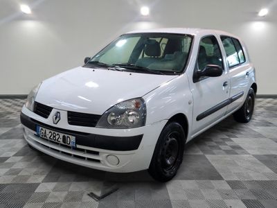 a picture of a small white car parked in a garage