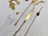 a collection of gold jewellery including a bracelet, ring, and other items