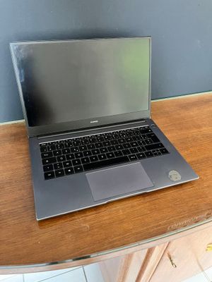 a laptop that is sitting on a wooden table