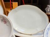 a lot of plates and bowls on the table