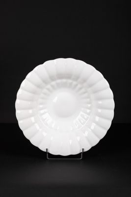 a white plate sitting on top of a black table