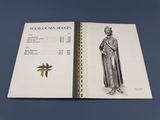 un livre ouvert sur lequel figure le dessin d'un homme en robe
