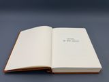 an open book sitting on top of a table next to a blue background