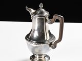 a silver tea pot sitting on a white table