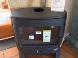 a black stove in the corner of a room