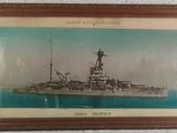 an old picture of a battleship in a frame on a wall