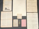 several old papers and a pair of scissors sit on a table