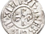 an old silver coin with a cross on it
