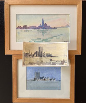 two watercolor paintings of a city and a lake in a wooden frame