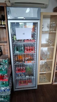 a refrigerator that has a lot of bottles of soda in it