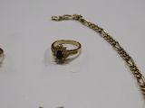 a necklace, ring, and bracelet that are on a table