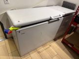 a white refrigerator sitting in the corner of a room
