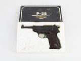 an image of a gun in a box on a white surface