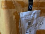 a bag with a tie on it sitting on the floor