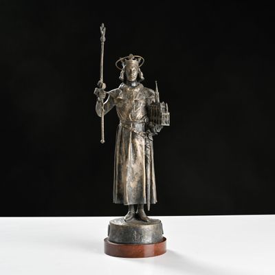 a silver statue of a man holding a sword and a shield