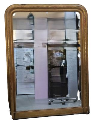 a mirror that is sitting on the floor in front of a building