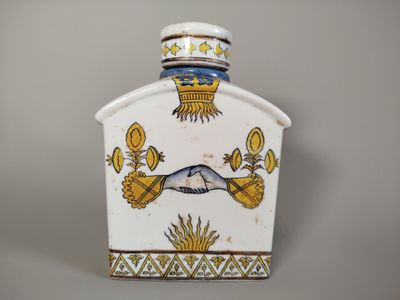 a white and blue vase with a bird on it