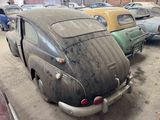 many old cars parked in a garage together