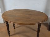 a small table with a wooden top on a tile floor