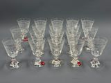 twelve wine glasses with red and white decorations on them