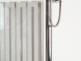 a mirror with a metal frame on the wall
