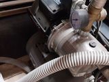 a machine that has a hose attached to it ' s side