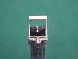 a close up of a watch on a green surface