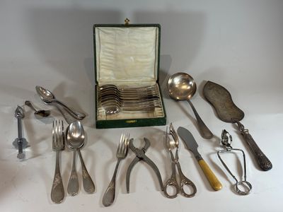 a lot of silverware on a table with a case