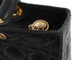 a close up of a black bag with a gold handle