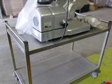 a machine that is sitting on a cart in a warehouse