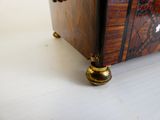 a small wooden box with a gold handle on a table