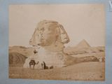 an old photo of a man riding a horse in front of a sphinx