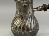 silver plated coffee pot with a wooden handle and a lid