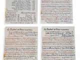 four pieces of paper with writing on them sitting on top of a table