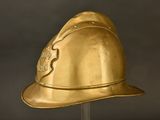 gold fireman ' s helmet on a clear stand against a black background