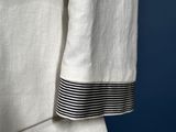 a close up of a white suit with black stripes on it