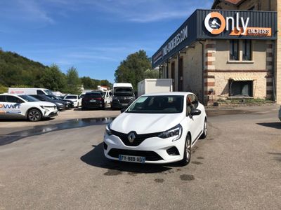 a white car parked in front of a building