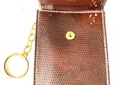 brown leather key case with a keychain on a white background
