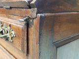 a close up of a wooden cabinet with a metal handle