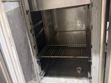 an open oven that is sitting inside of a building