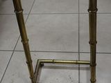 a metal stand that has a glass top on it