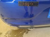 a close up of a blue car with a sticker on it