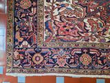 rug on a tiled floor in a room with red and blue tiles