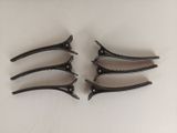 four pairs of clamps on a white surface with a white background