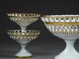 three white and gold glass bowls sitting on top of each other