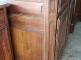 a wooden cabinet with a marble top next to a wooden cabinet